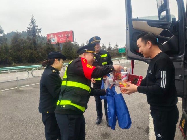 2026年2月12日，S25沿榕高速思剑段镇远管段白杨坪服务区，贵州省交通运输综合行政执法七支六大队与“一路多方”工作人员到广场内停靠的大货车旁，将方便面、春联、法律法规宣传手册送到驾驶员手中，贵州省交通运输综合行政执法七支队六大队（杨富 摄）.jpg