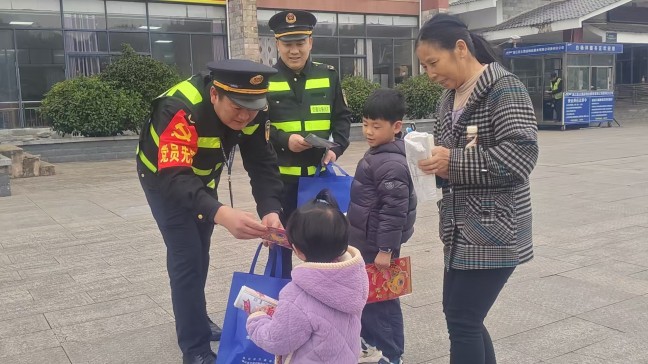 2026年2月12日，S25沿榕高速思剑段镇远管段白杨坪服务区，贵州省交通运输综合行政执法七支队六大执法人员给司乘人员送春联，贵州省交通运输综合行政执法七支队六大队（杨富 摄）  (3).jpg